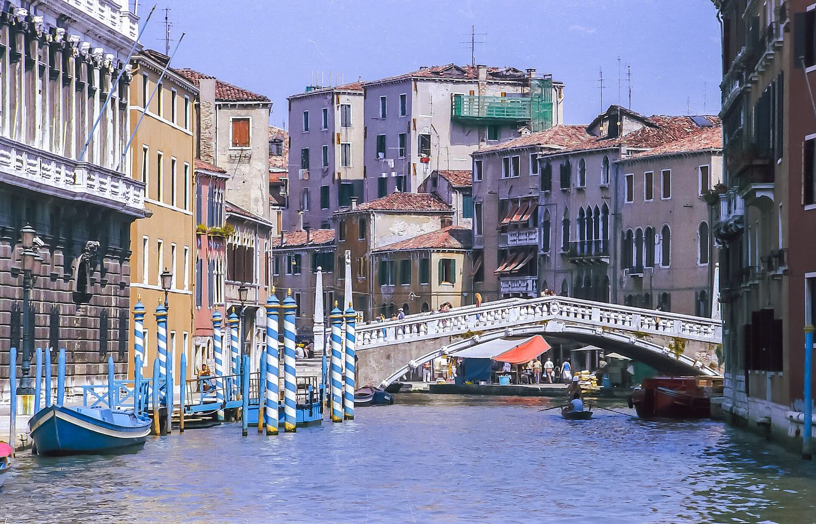 The Ponte delle Guglie crossing the Cannaregio Canal, with stone obelisks at each end and striped mooring poles in front